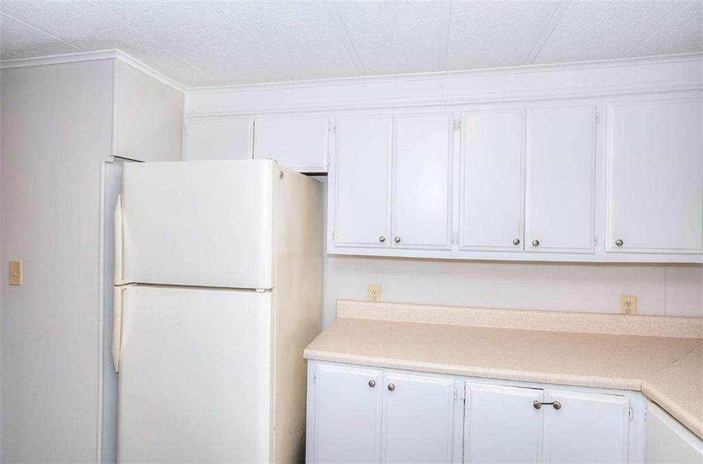 1210 Lee Peters Road Loganville, GA 30052 - Photo 10 of 32 a white refrigerator freezer sitting in a kitchen