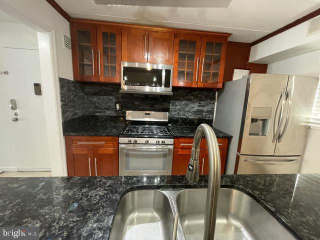 3346 Hewitt Avenue, Unit 11A Silver Spring, MD 20906 - Photo 15 of 16 a kitchen with stainless steel appliances granite countertop a refrigerator a stove top oven and a sink