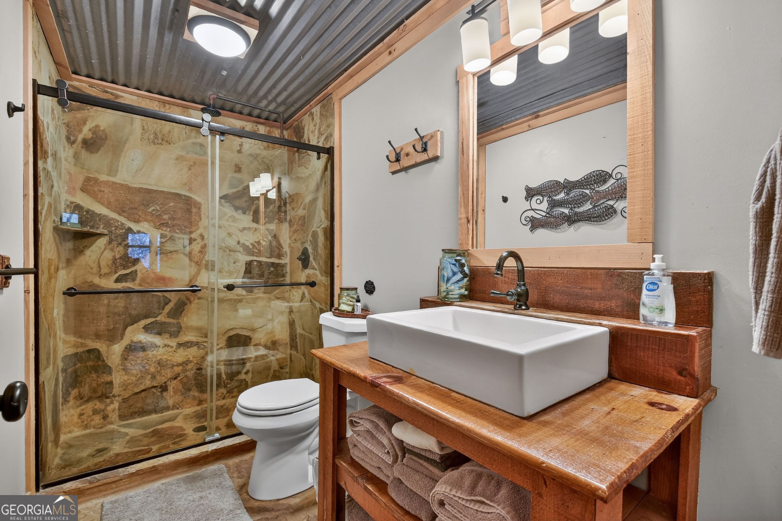 134 Hemlock Circle, Unit 54 Blue Ridge, GA 30513 - Photo 20 of 43 a bathroom with a sink a toilet and shower