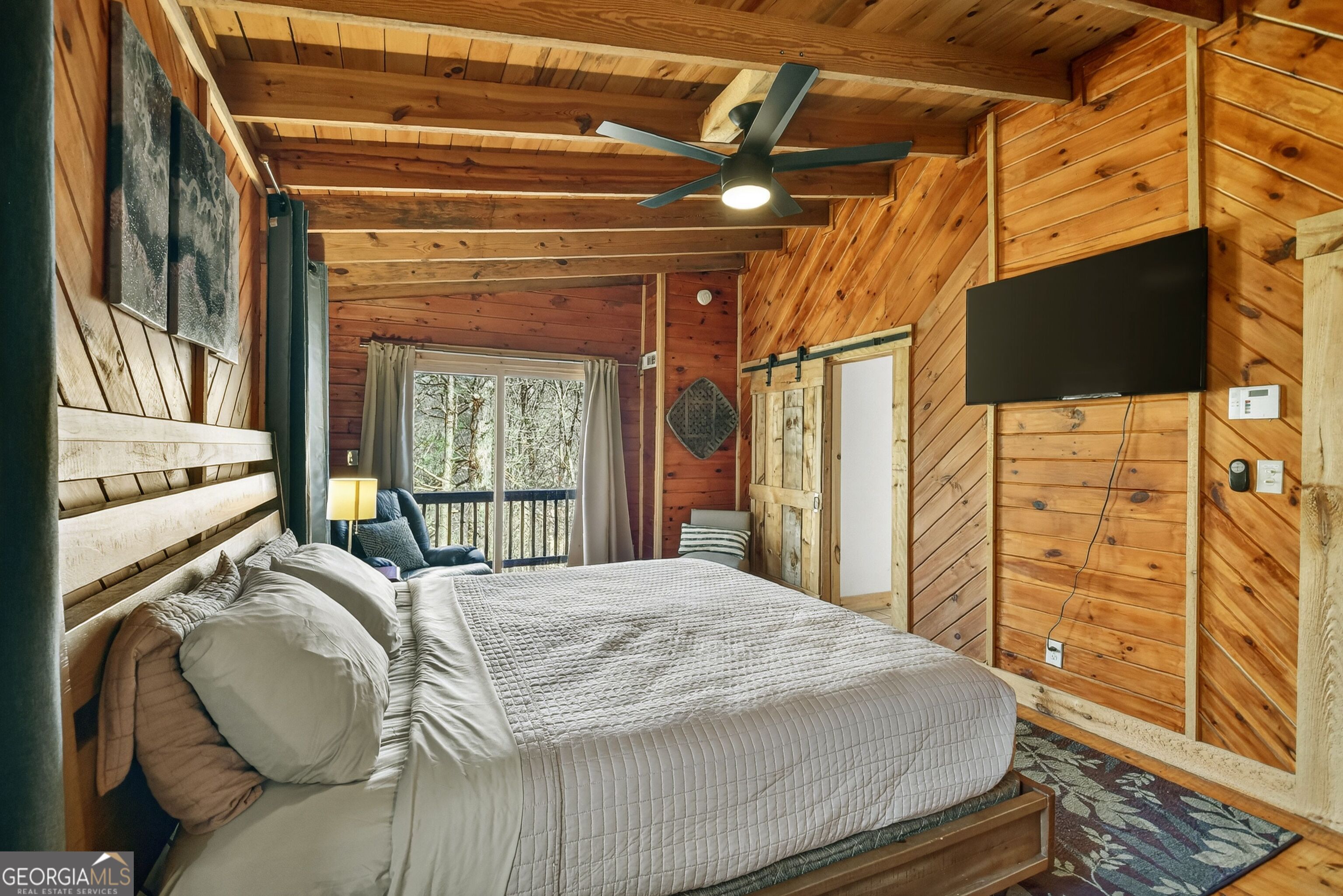 134 Hemlock Circle, Unit 54 Blue Ridge, GA 30513 - Photo 25 of 43 a bed sitting in a bedroom next to a window