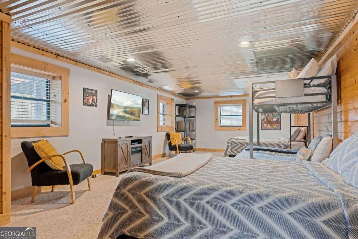 134 Hemlock Circle, Unit 54 Blue Ridge, GA 30513 - Photo 34 of 43 a large bedroom with bed and wooden floor