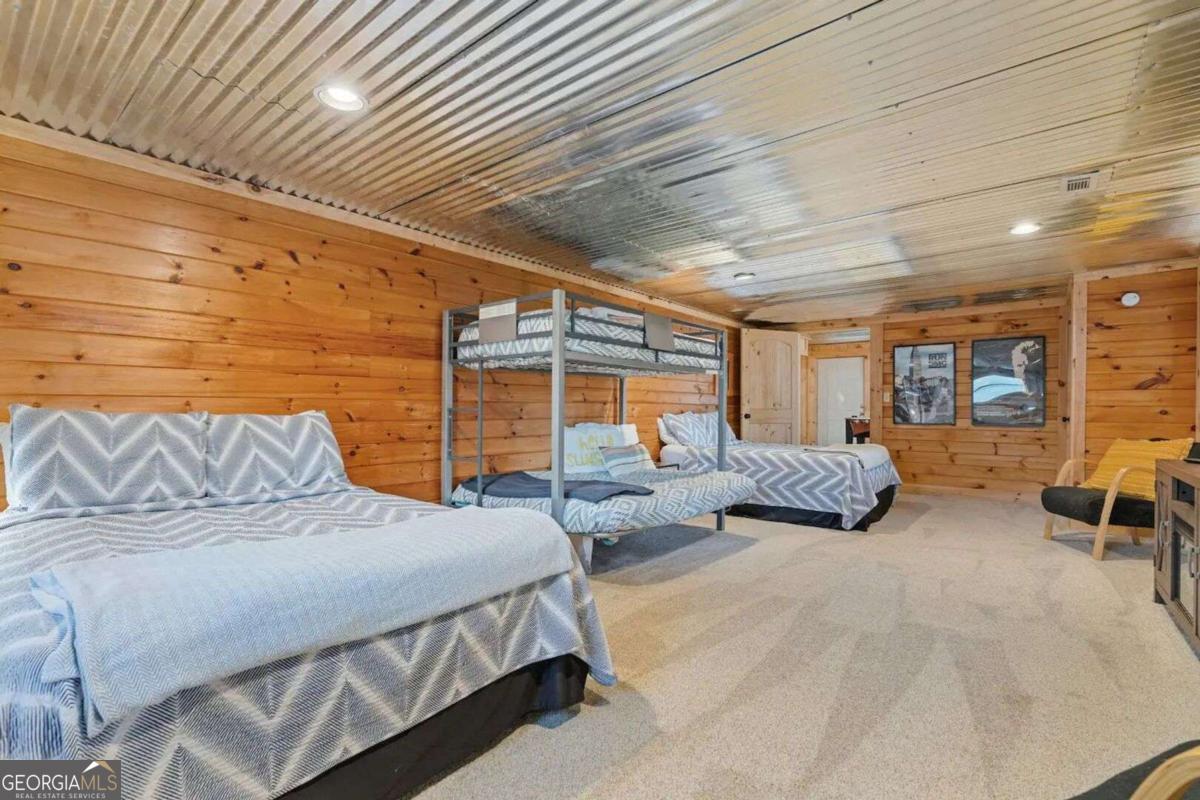 134 Hemlock Circle, Unit 54 Blue Ridge, GA 30513 - Photo 35 of 43 a spacious bedroom with two beds and a couch