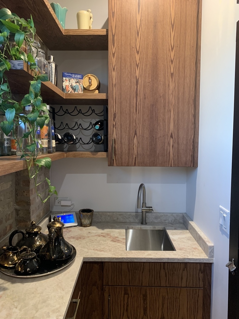 5259 West Roscoe Street, Unit 1F Chicago, IL 60641 - Photo 14 of 53 a kitchen with a sink and cabinets