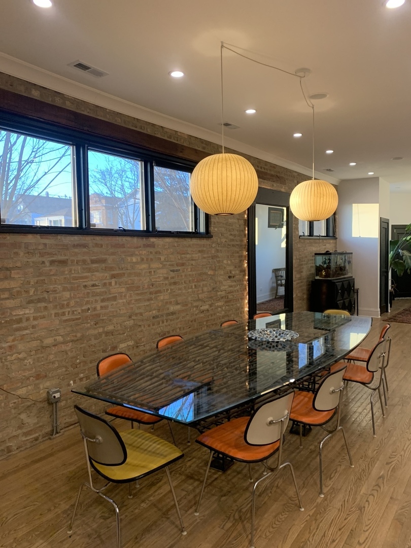 5259 West Roscoe Street, Unit 1F Chicago, IL 60641 - Photo 2 of 53 a room with table chairs and a large window