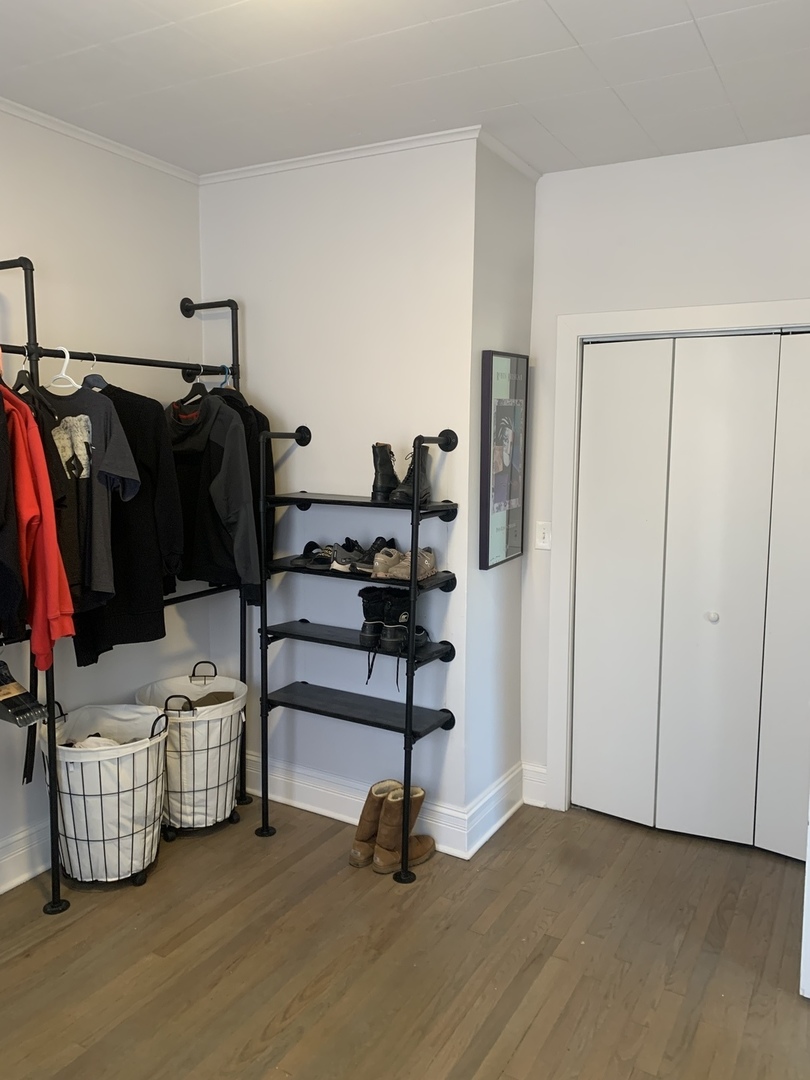 5259 West Roscoe Street, Unit 1F Chicago, IL 60641 - Photo 23 of 53 a bedroom with a window and gym equipment