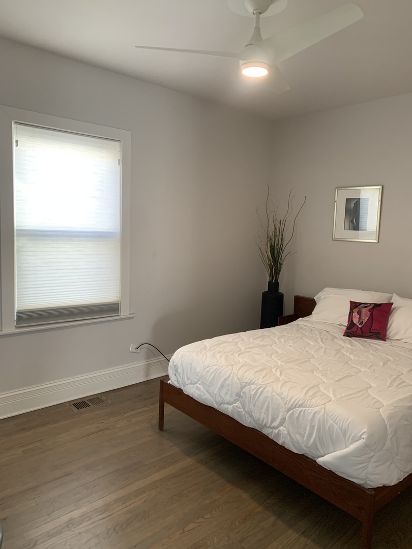 5259 West Roscoe Street, Unit 1F Chicago, IL 60641 - Photo 27 of 53 a bedroom with a bed and a window