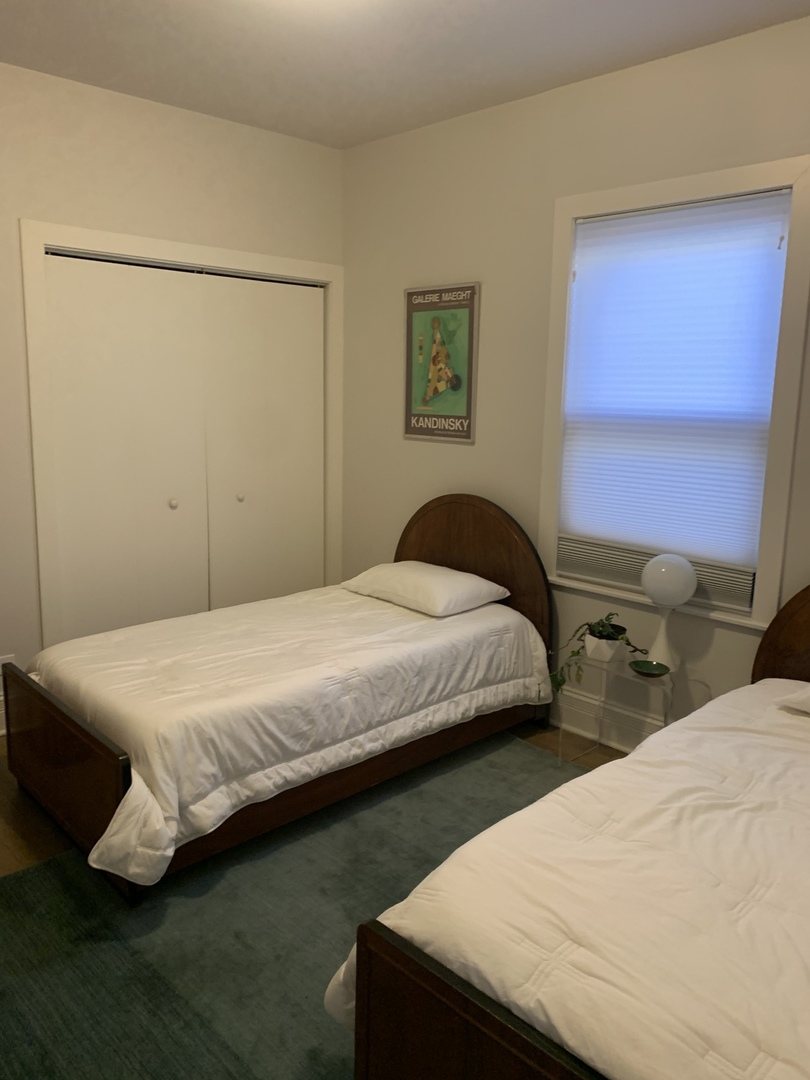 5259 West Roscoe Street, Unit 1F Chicago, IL 60641 - Photo 28 of 53 a bedroom with bed and a closet