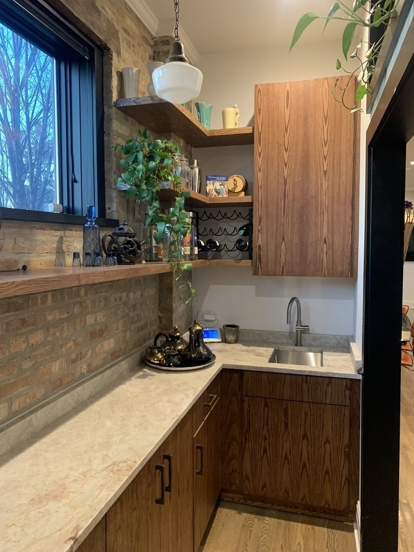 5259 West Roscoe Street, Unit 1F Chicago, IL 60641 - Photo 32 of 53 a kitchen with a sink and cabinets
