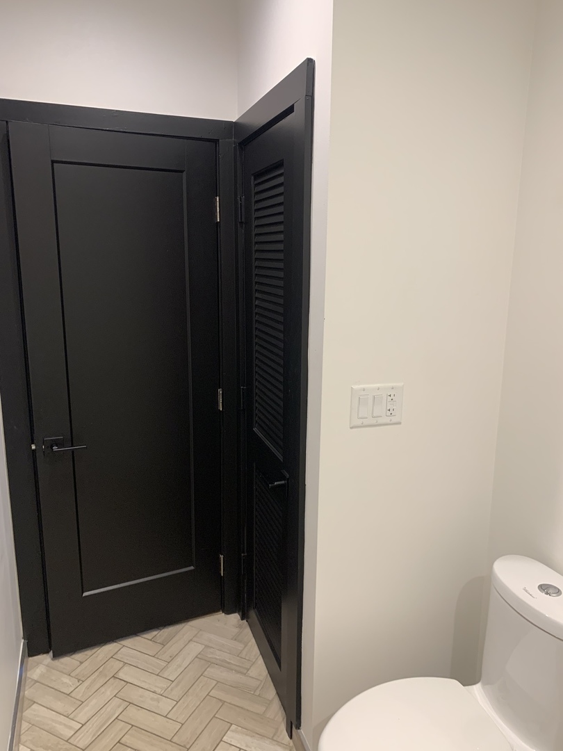 5259 West Roscoe Street, Unit 1F Chicago, IL 60641 - Photo 35 of 53 a bathroom with a sink and a toilet