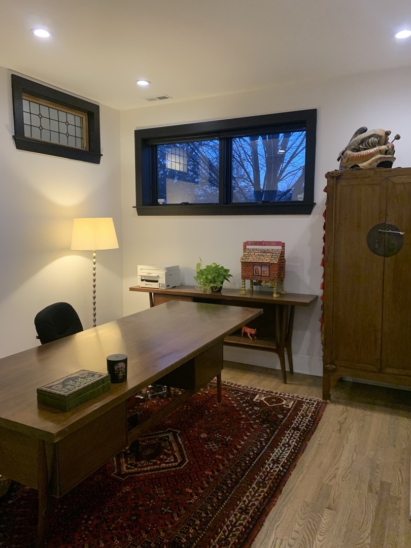 5259 West Roscoe Street, Unit 1F Chicago, IL 60641 - Photo 39 of 53 a living room with furniture and a flat screen tv