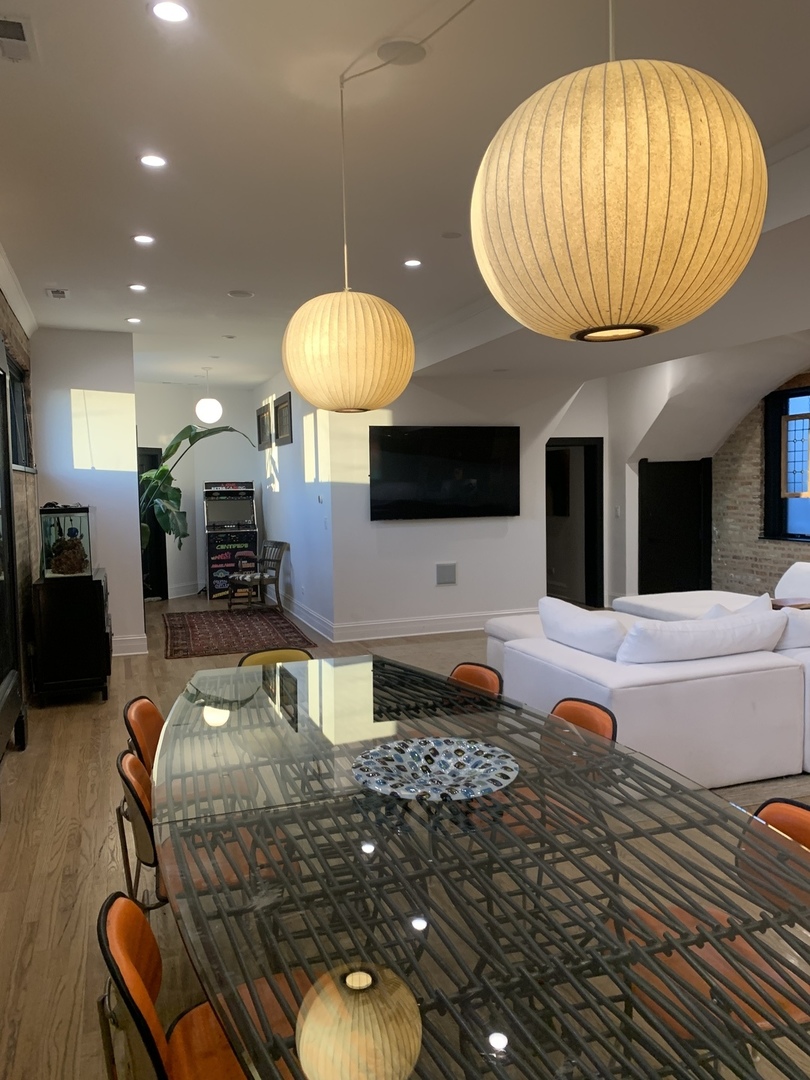 5259 West Roscoe Street, Unit 1F Chicago, IL 60641 - Photo 4 of 53 a kitchen with a table and chairs in it