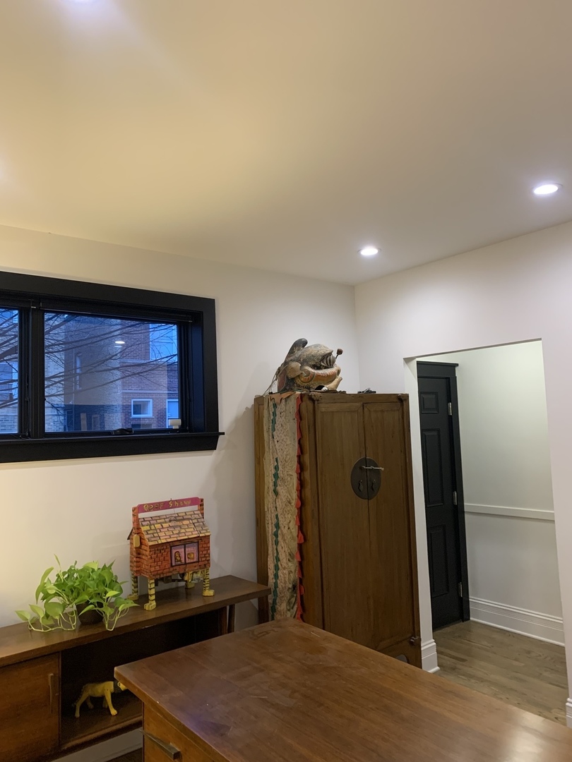 5259 West Roscoe Street, Unit 1F Chicago, IL 60641 - Photo 41 of 53 a view of a refrigerator in kitchen and an empty room