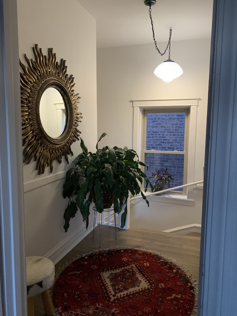 5259 West Roscoe Street, Unit 1F Chicago, IL 60641 - Photo 42 of 53 a bathroom with a sink a mirror and vanity