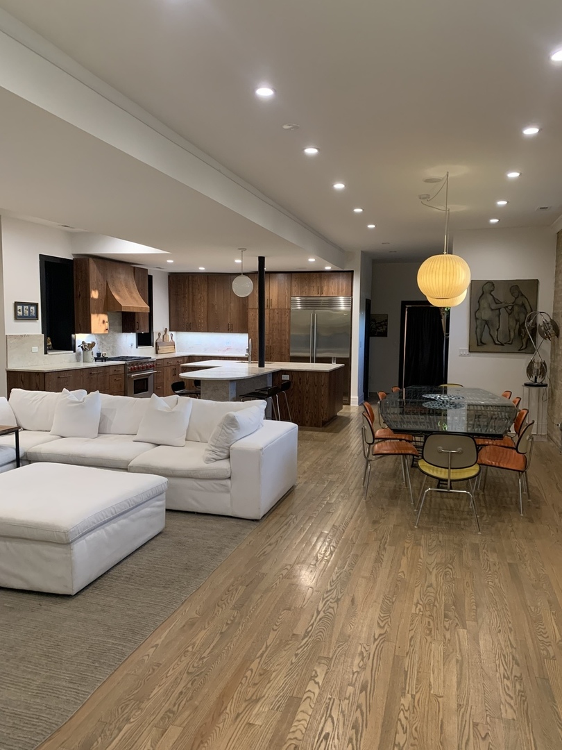 5259 West Roscoe Street, Unit 1F Chicago, IL 60641 - Photo 5 of 53 a living room with furniture and a flat screen tv