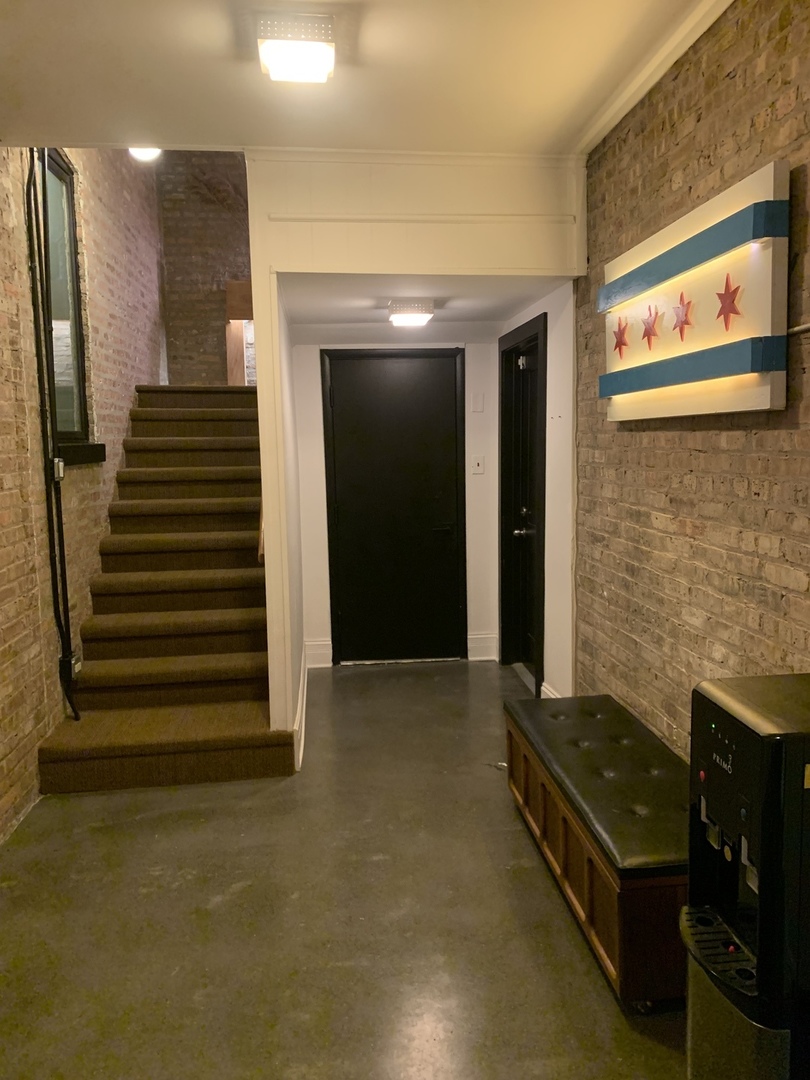 5259 West Roscoe Street, Unit 1F Chicago, IL 60641 - Photo 53 of 53 a view of an empty room and wooden floor