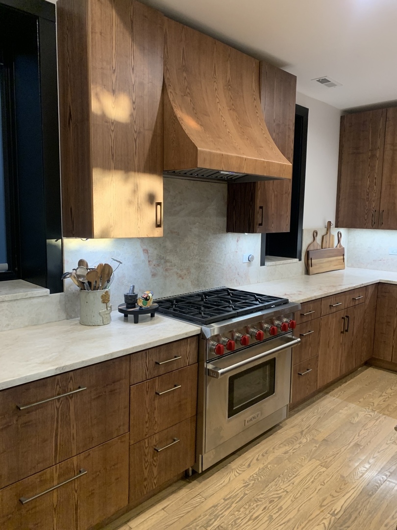 5259 West Roscoe Street, Unit 1F Chicago, IL 60641 - Photo 6 of 53 a kitchen with stainless steel appliances a sink stove and cabinets