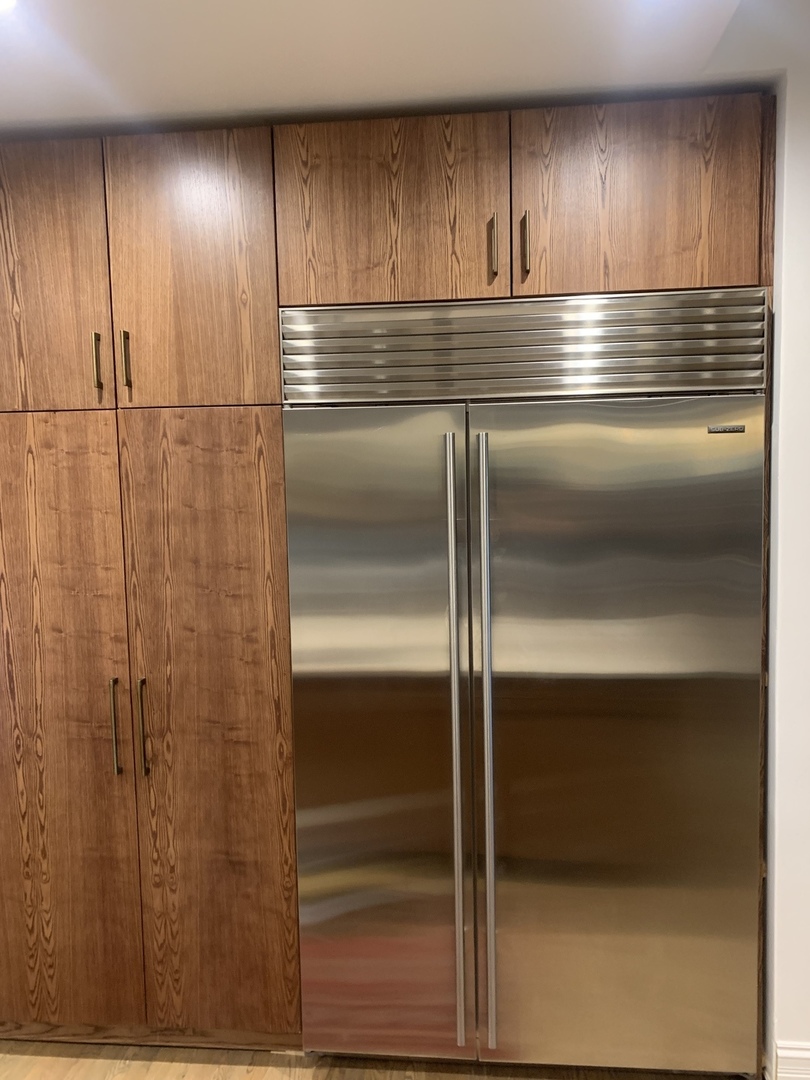 5259 West Roscoe Street, Unit 1F Chicago, IL 60641 - Photo 9 of 53 a kitchen with kitchen island and wooden floor