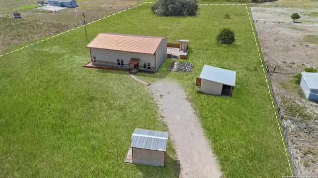 an aerial view of a house with outdoor space patio and mountain view