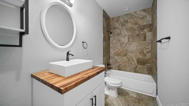 a view of a livingroom with furniture a fireplace entryway and wooden floor