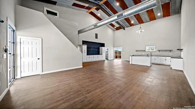 an aerial view of a house with a garden and lake view