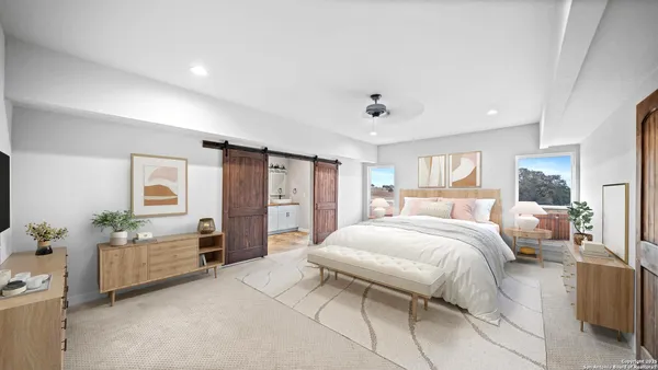 a bedroom with a large bed and furniture