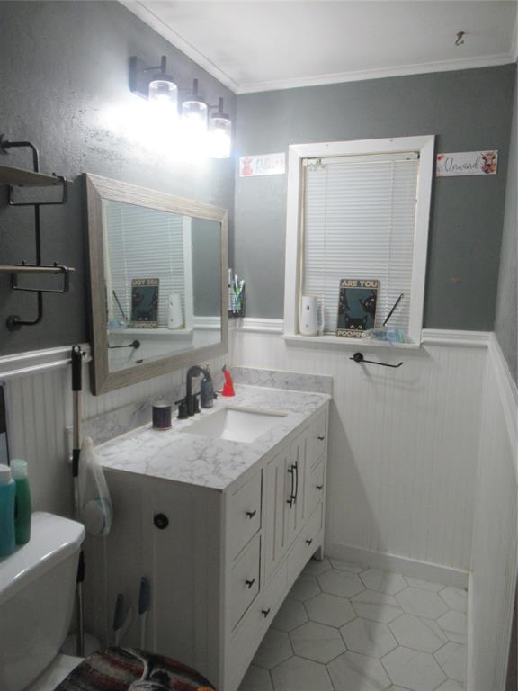 24133 Highway 157 Springhill, LA 71075 - Photo 16 of 19 Bathroom featuring a white vanity with an integrated sink, a gray countertop, and white wainscoting