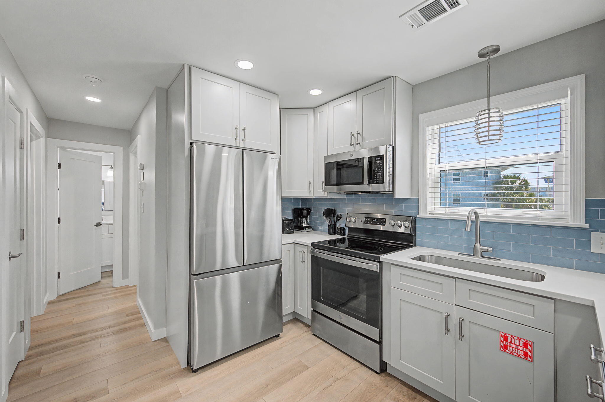 11 Beachside Drive, Unit 523 Santa Rosa Beach, FL 32459 - Photo 10 of 32 a kitchen with white cabinets stainless steel appliances and a window