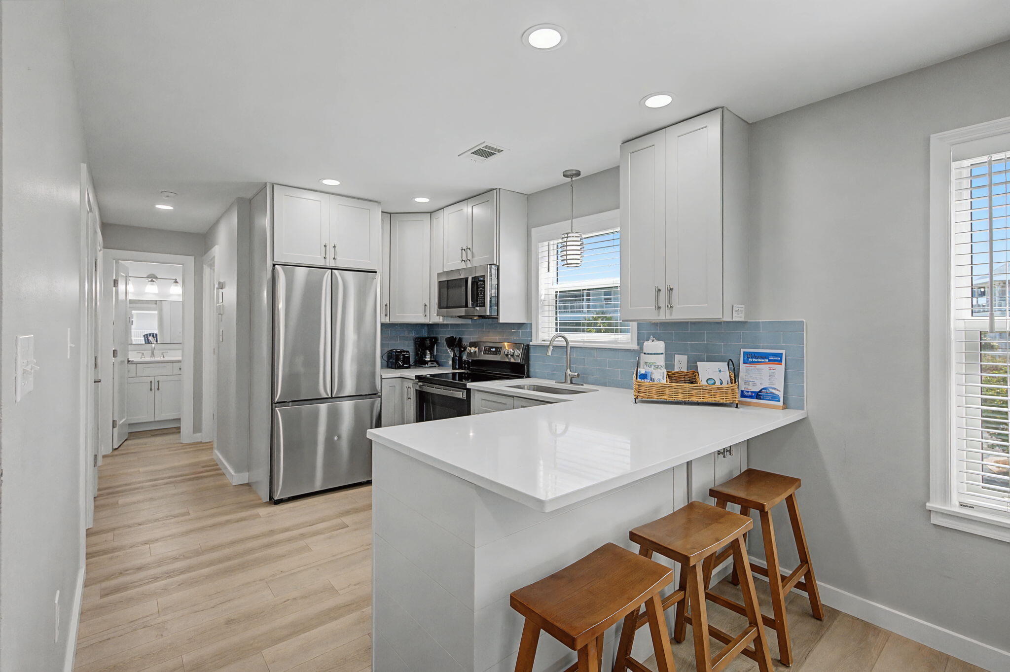 11 Beachside Drive, Unit 523 Santa Rosa Beach, FL 32459 - Photo 12 of 32 a kitchen with stainless steel appliances a refrigerator stove microwave and white cabinets