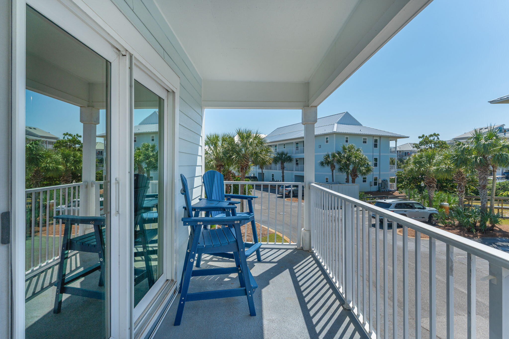 11 Beachside Drive, Unit 523 Santa Rosa Beach, FL 32459 - Photo 23 of 32 a view of a balcony with chairs and wooden fence