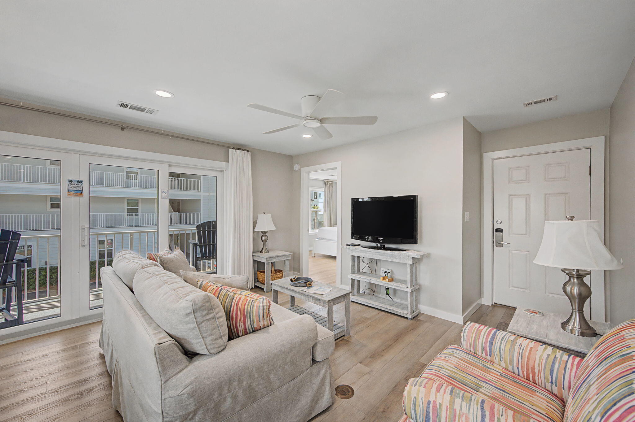 11 Beachside Drive, Unit 523 Santa Rosa Beach, FL 32459 - Photo 4 of 32 a living room with furniture and a flat screen tv