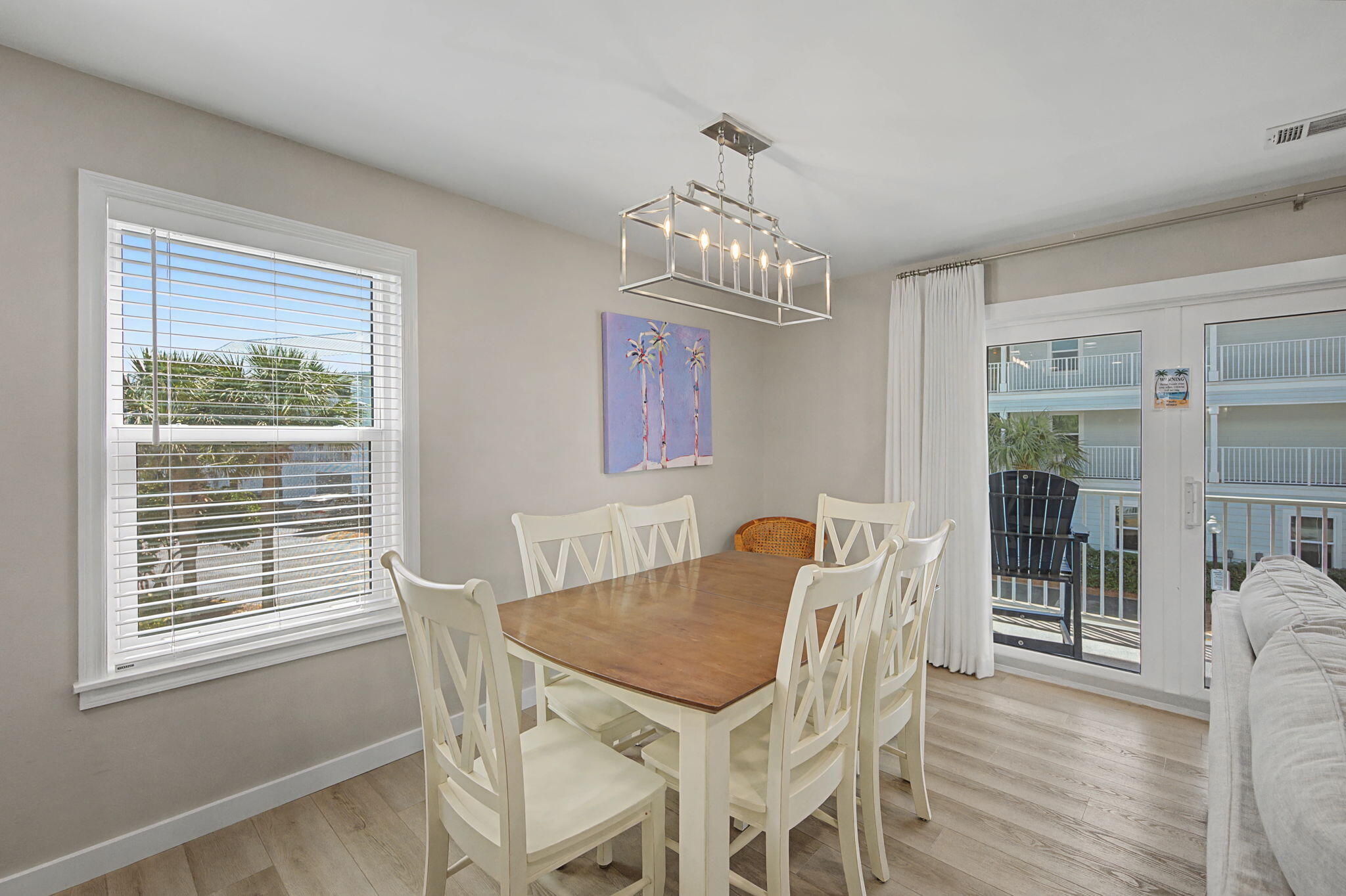 11 Beachside Drive, Unit 523 Santa Rosa Beach, FL 32459 - Photo 7 of 32 a view of a dining room with furniture wooden floor and chandelier