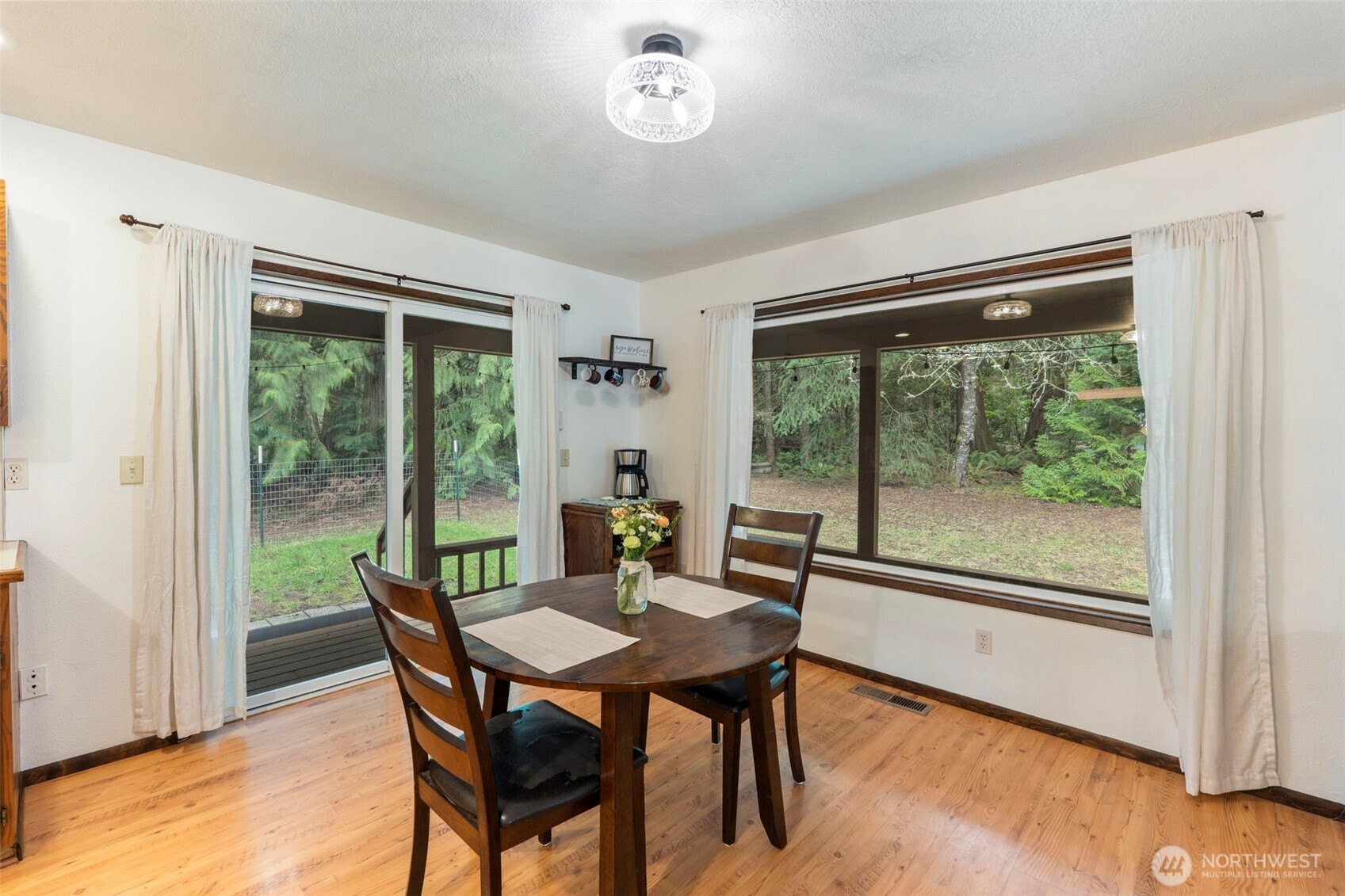 209 Alpha Way Onalaska, WA 98570 - Photo 13 of 40 a view of a dining room with furniture window and wooden floor