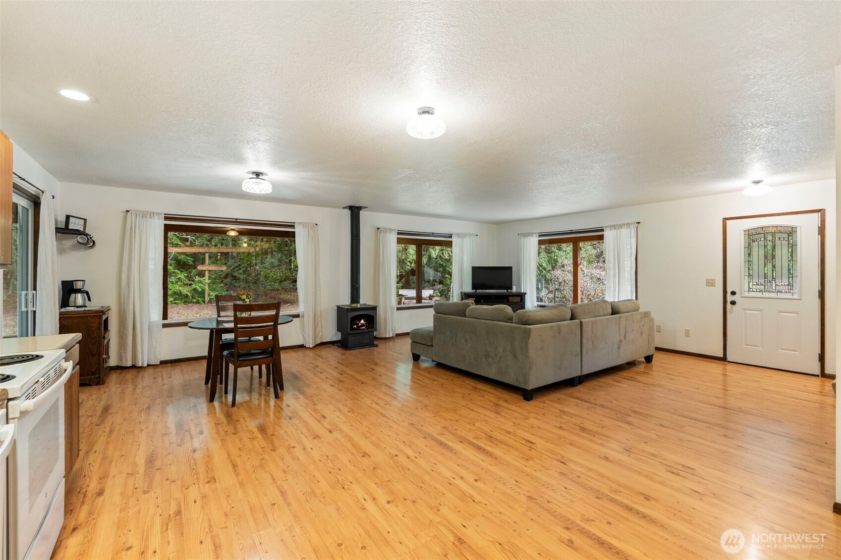 209 Alpha Way Onalaska, WA 98570 - Photo 14 of 40 a living room with furniture and a wooden floor