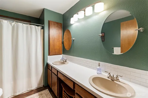a bathroom with a double vanity sink and mirror