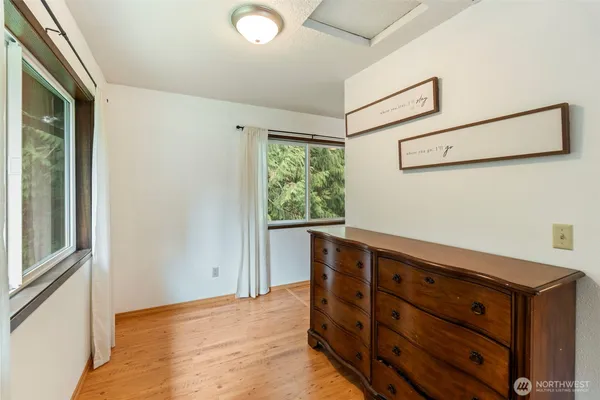 a room with a dresser and a window