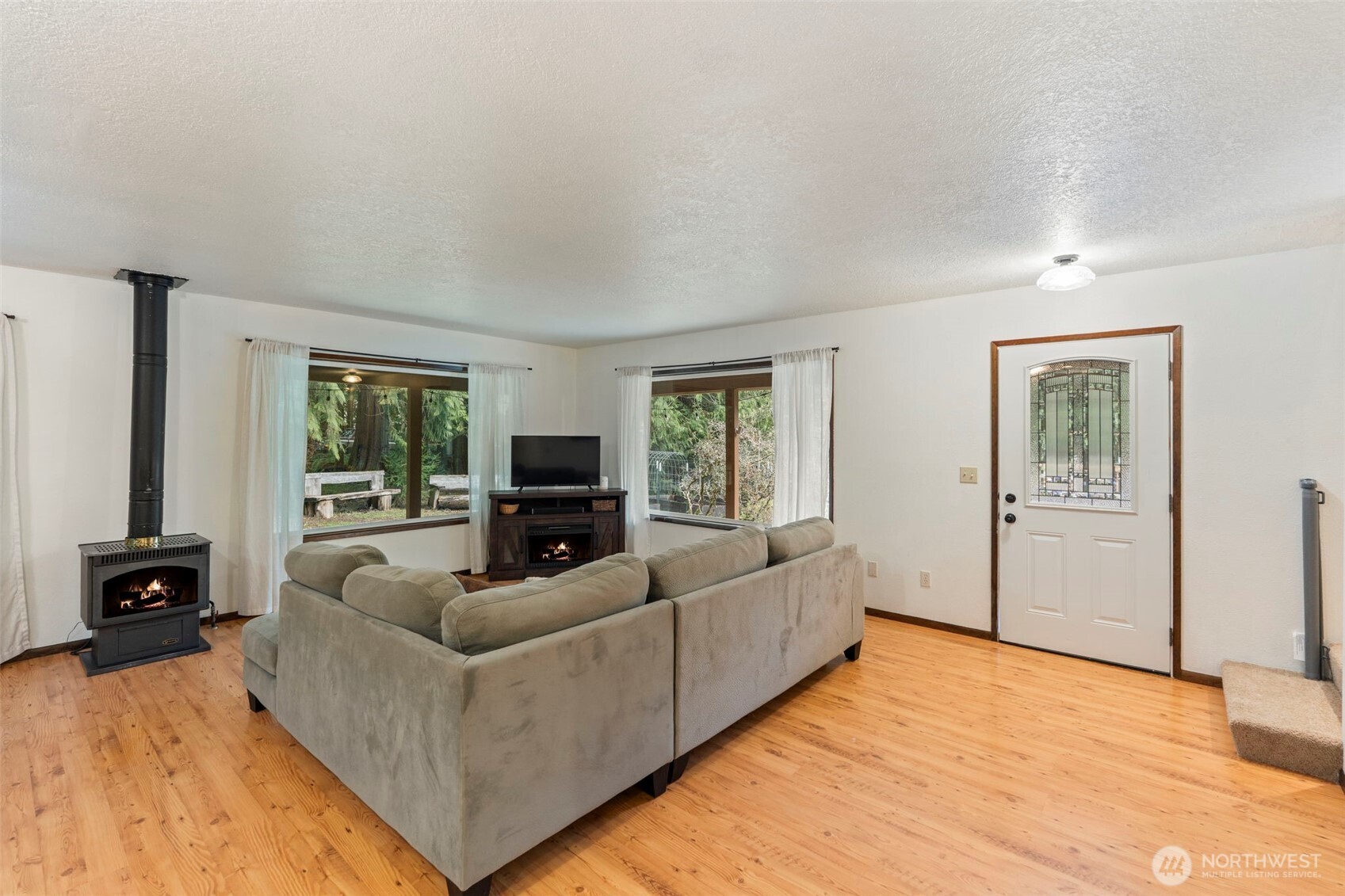 209 Alpha Way Onalaska, WA 98570 - Photo 8 of 40 a living room with furniture and a flat screen tv