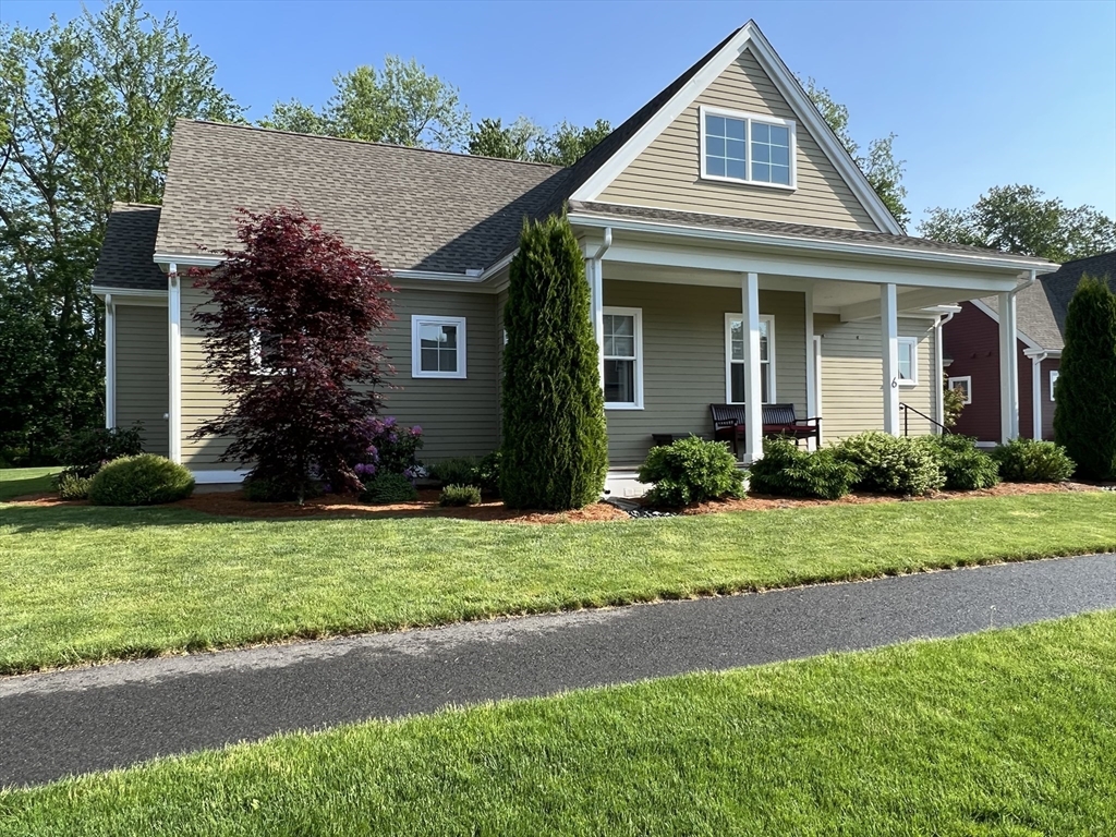 6 East Commons Drive, Unit 6 Hadley, MA 01035 - Photo 1 of 27 a front view of a house with a yard