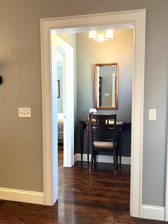 6 East Commons Drive, Unit 6 Hadley, MA 01035 - Photo 12 of 27 a view of a room with wooden floor a glass table and windows