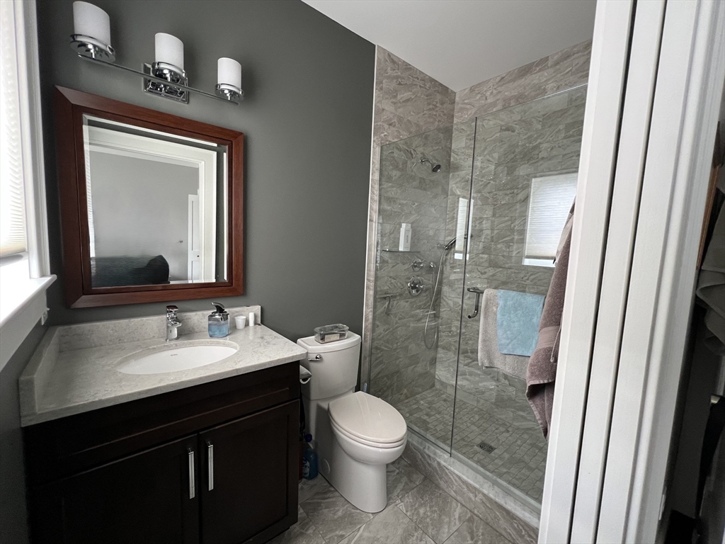 6 East Commons Drive, Unit 6 Hadley, MA 01035 - Photo 15 of 27 a bathroom with a sink a toilet and shower