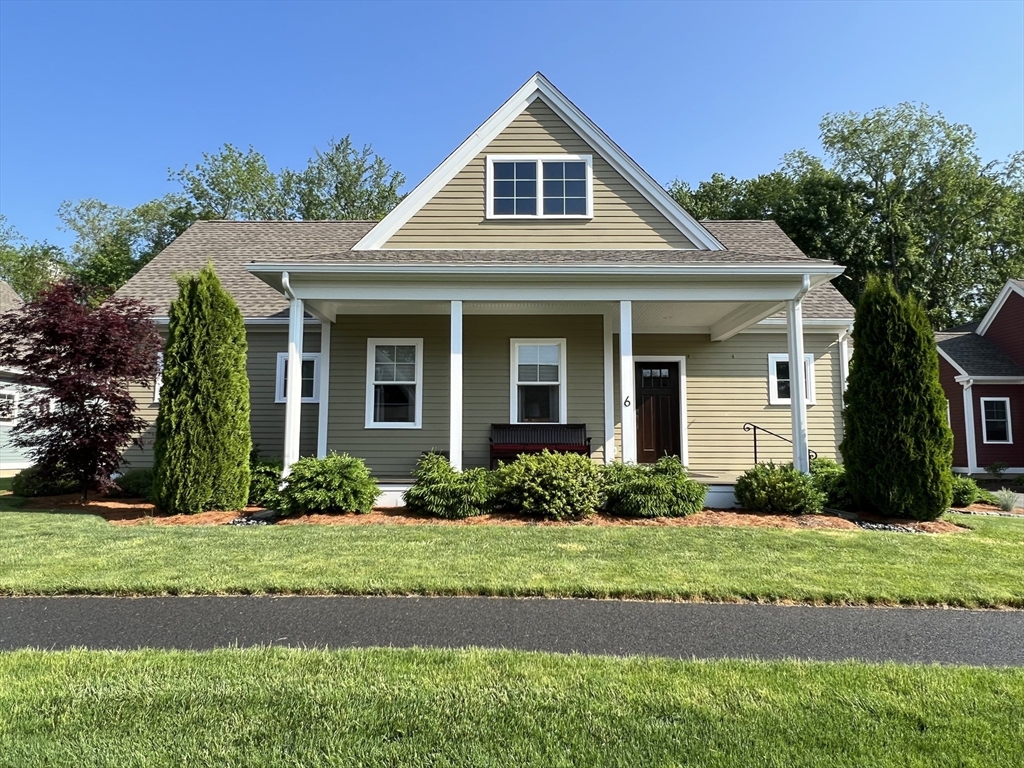 6 East Commons Drive, Unit 6 Hadley, MA 01035 - Photo 2 of 27 a front view of a house with a yard