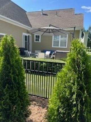 6 East Commons Drive, Unit 6 Hadley, MA 01035 - Photo 22 of 27 a view of a house with a small yard and potted plants