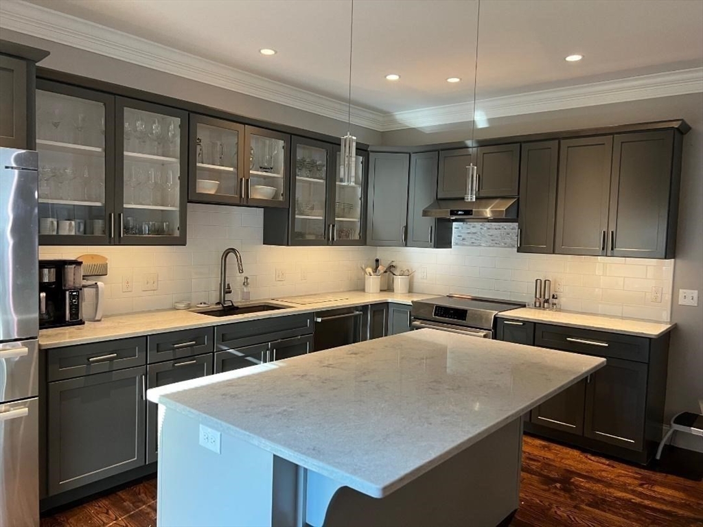 6 East Commons Drive, Unit 6 Hadley, MA 01035 - Photo 6 of 27 a kitchen with stainless steel appliances granite countertop a sink a stove and a refrigerator