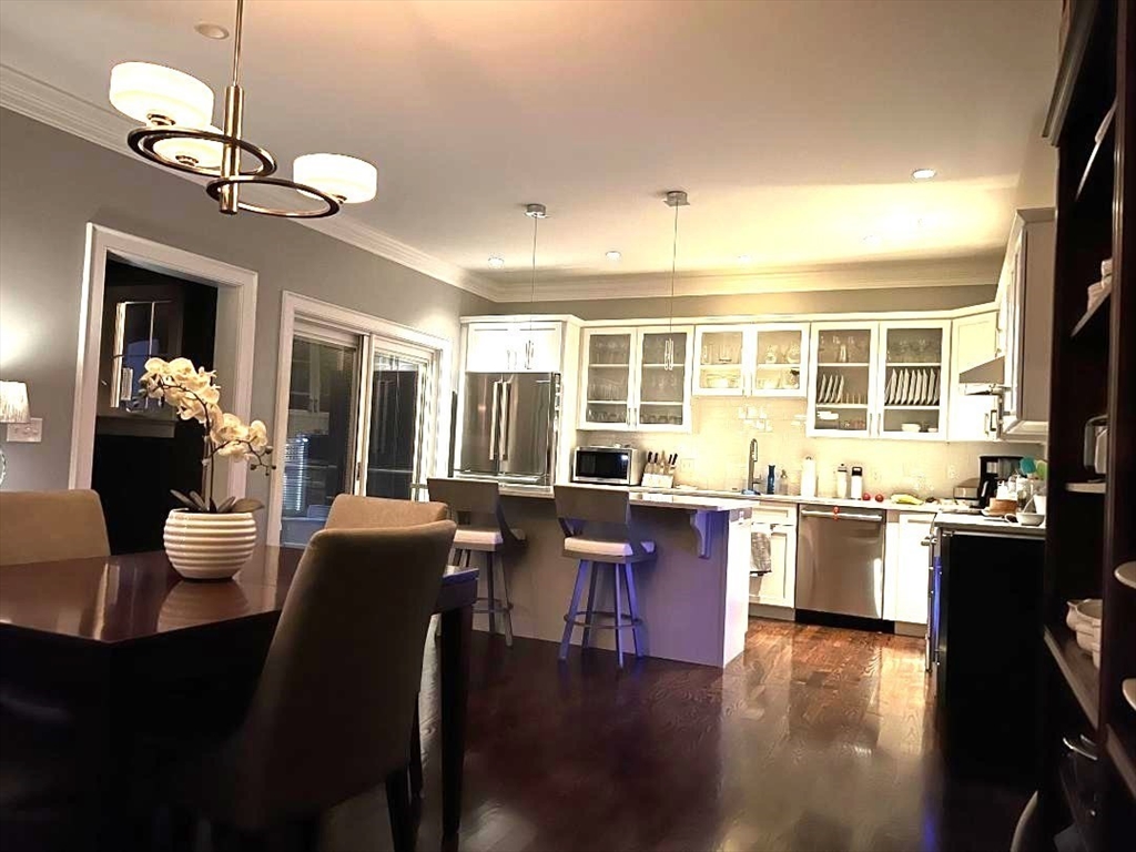 6 East Commons Drive, Unit 6 Hadley, MA 01035 - Photo 7 of 27 a view of a dining room with furniture a chandelier and wooden floor