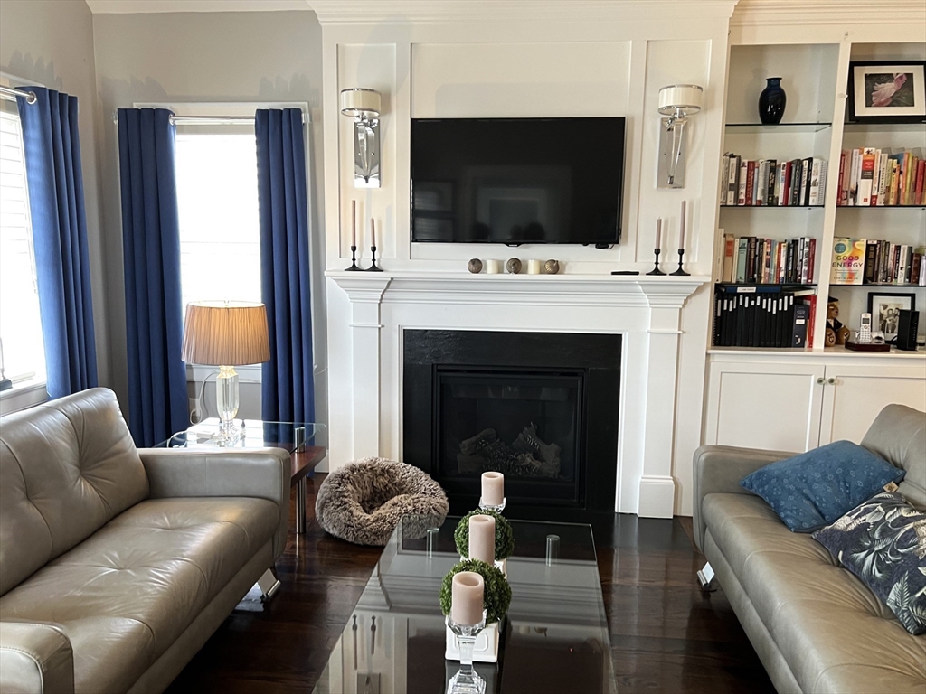 6 East Commons Drive, Unit 6 Hadley, MA 01035 - Photo 10 of 27 a living room with furniture a flat screen tv and a fireplace