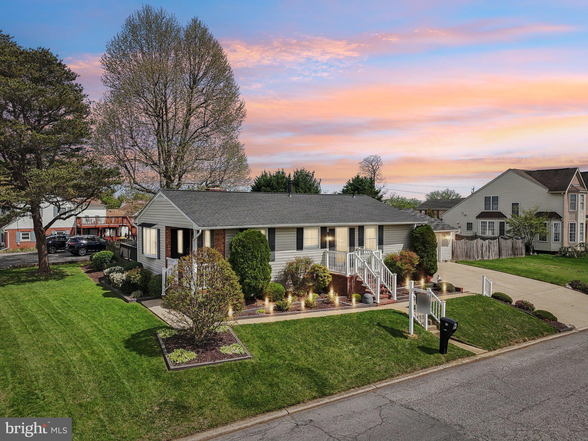 a front view of house with yard and green space