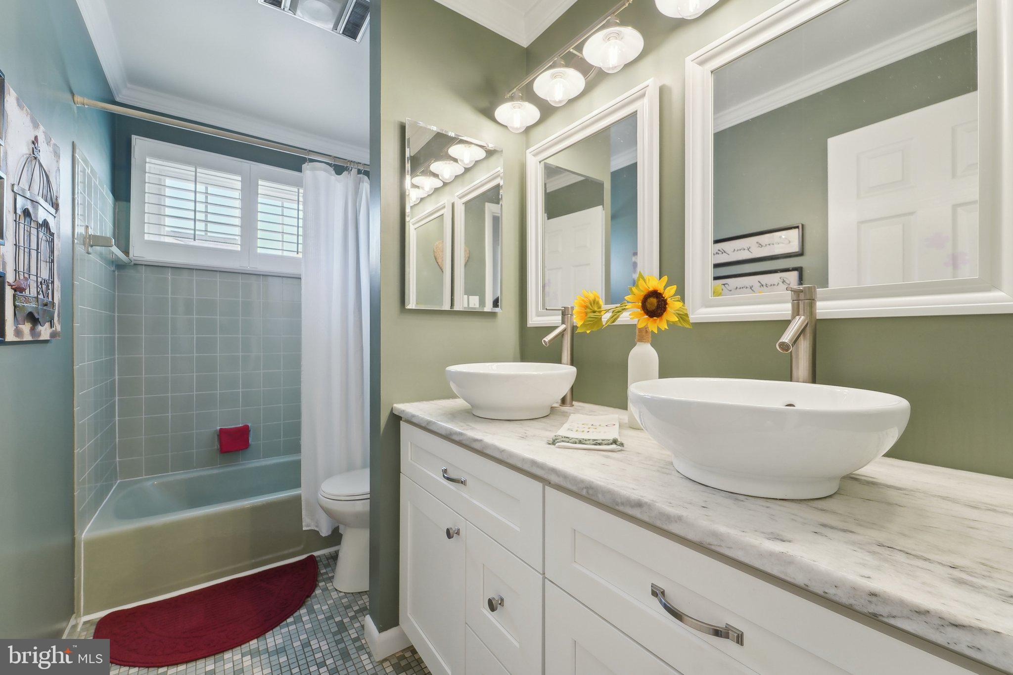 901 Mark Road Baltimore, MD 21225 - Photo 17 of 39 a bathroom with a granite countertop sink mirror bathtub and next to a window