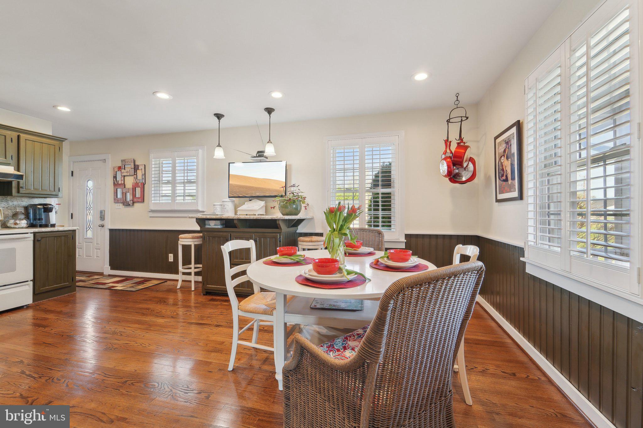 901 Mark Road Baltimore, MD 21225 - Photo 6 of 39 a dining room with furniture a wooden floor and a kitchen