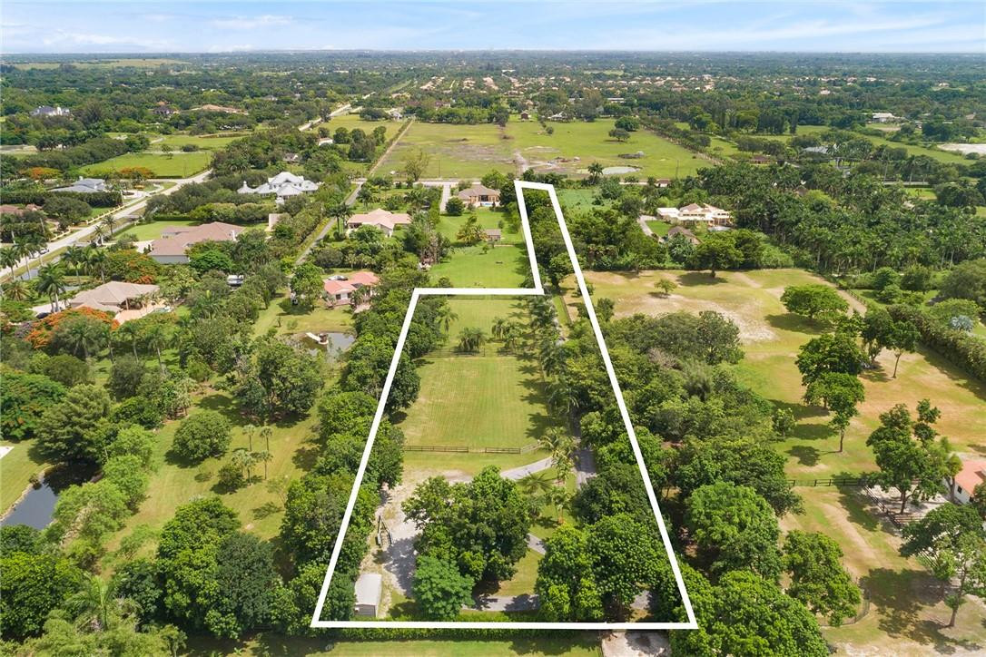 13470 Stirling Road Southwest Ranches, FL 33330 - Photo 2 of 13 an aerial view of residential houses with swimming pool