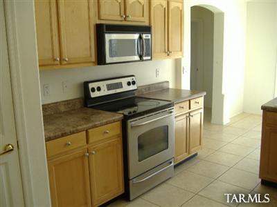 155 Paseo Dulzura Rio Rico, AZ 85648 - Photo 15 of 20 a kitchen with stainless steel appliances granite countertop a stove and a microwave