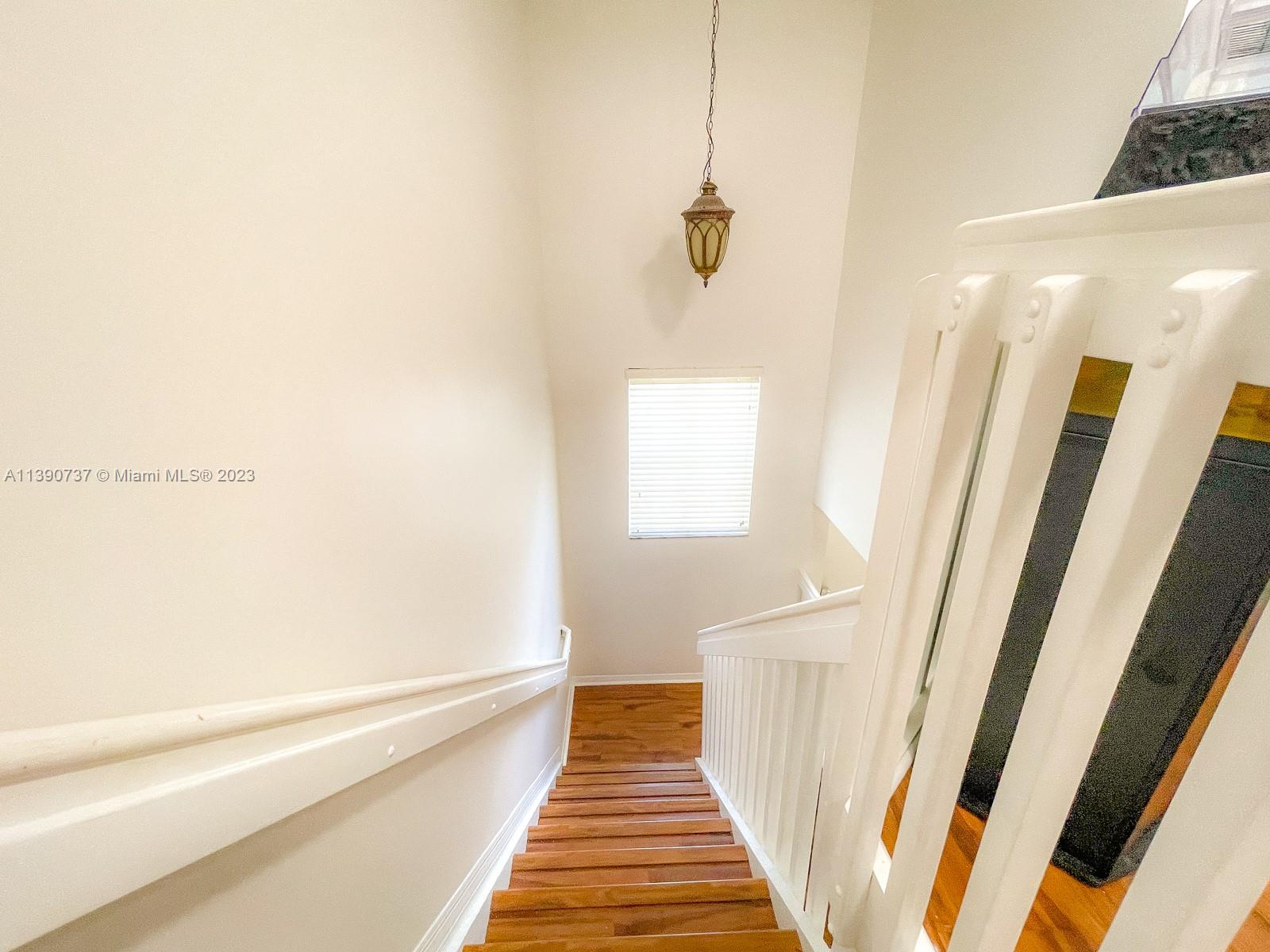 3136 Southwest 129th Way, Unit 157 Miramar, FL 33027 - Photo 11 of 23 a view of a hallway with wooden floor and staircase